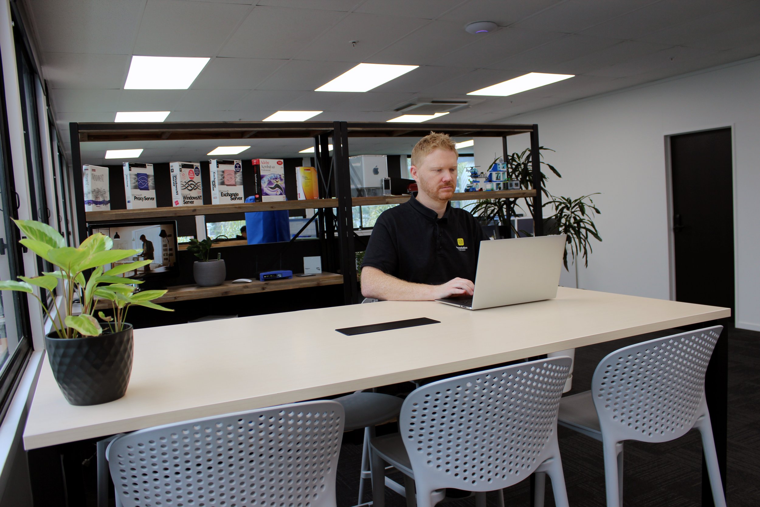 Working at a laptop in the New Solutions office