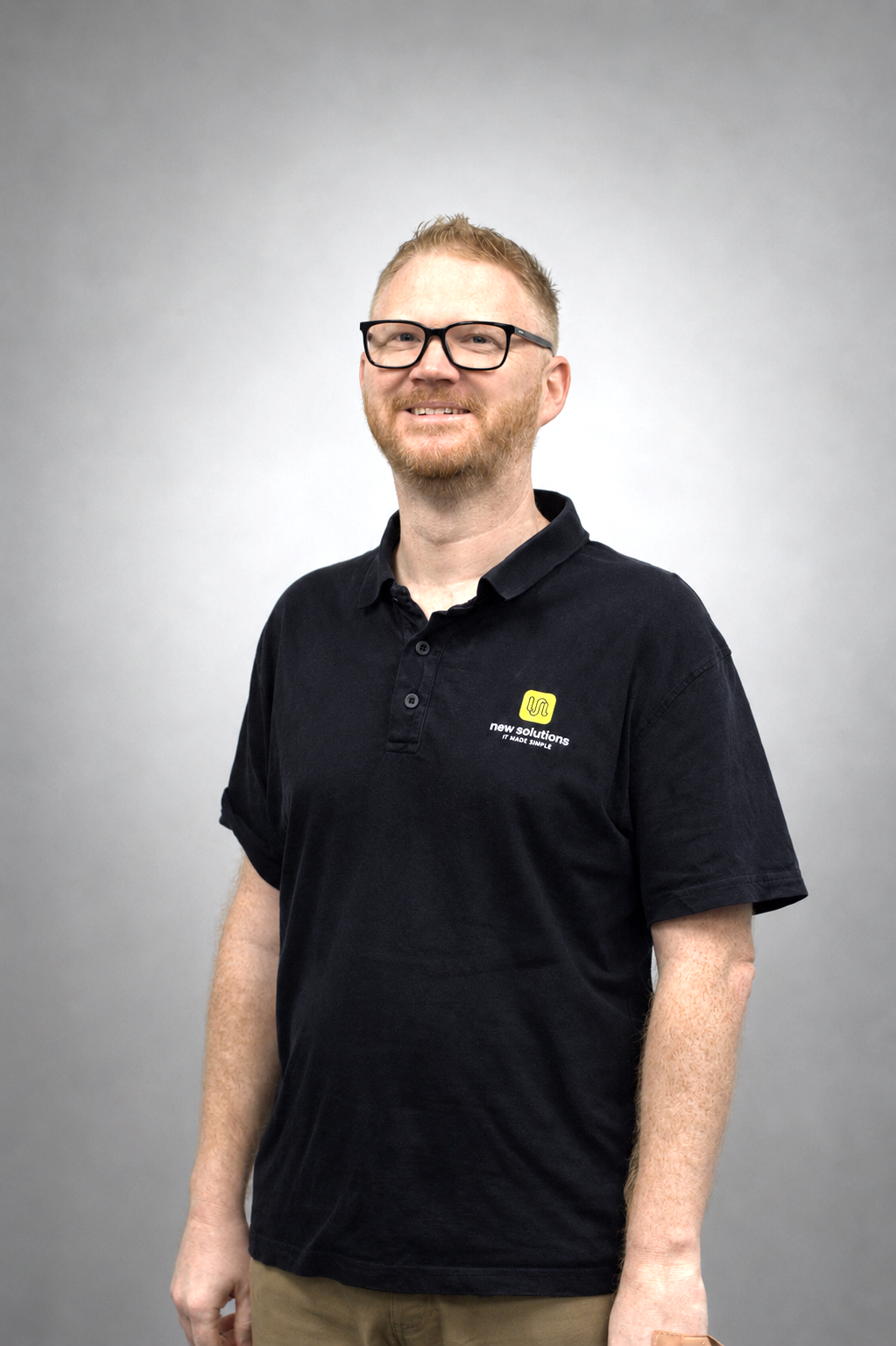 Philip Parkinson wearing a black polo shirt with the New Solutions logo